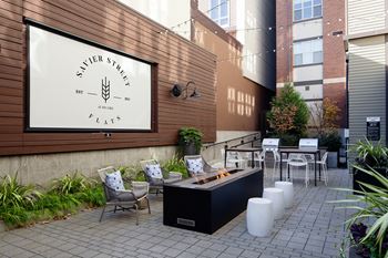 Outdoor courtyard lounge with projection screen